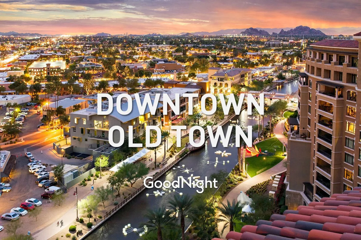 A sweeping view of the city skyline with palm trees, a waterfront, and mountains in the distance. The lively scene hints at nearby dining, art galleries, and local exploration, capturing Scottsdale’s urban vibrancy and proximity to activities ideal for business travelers during downtime.