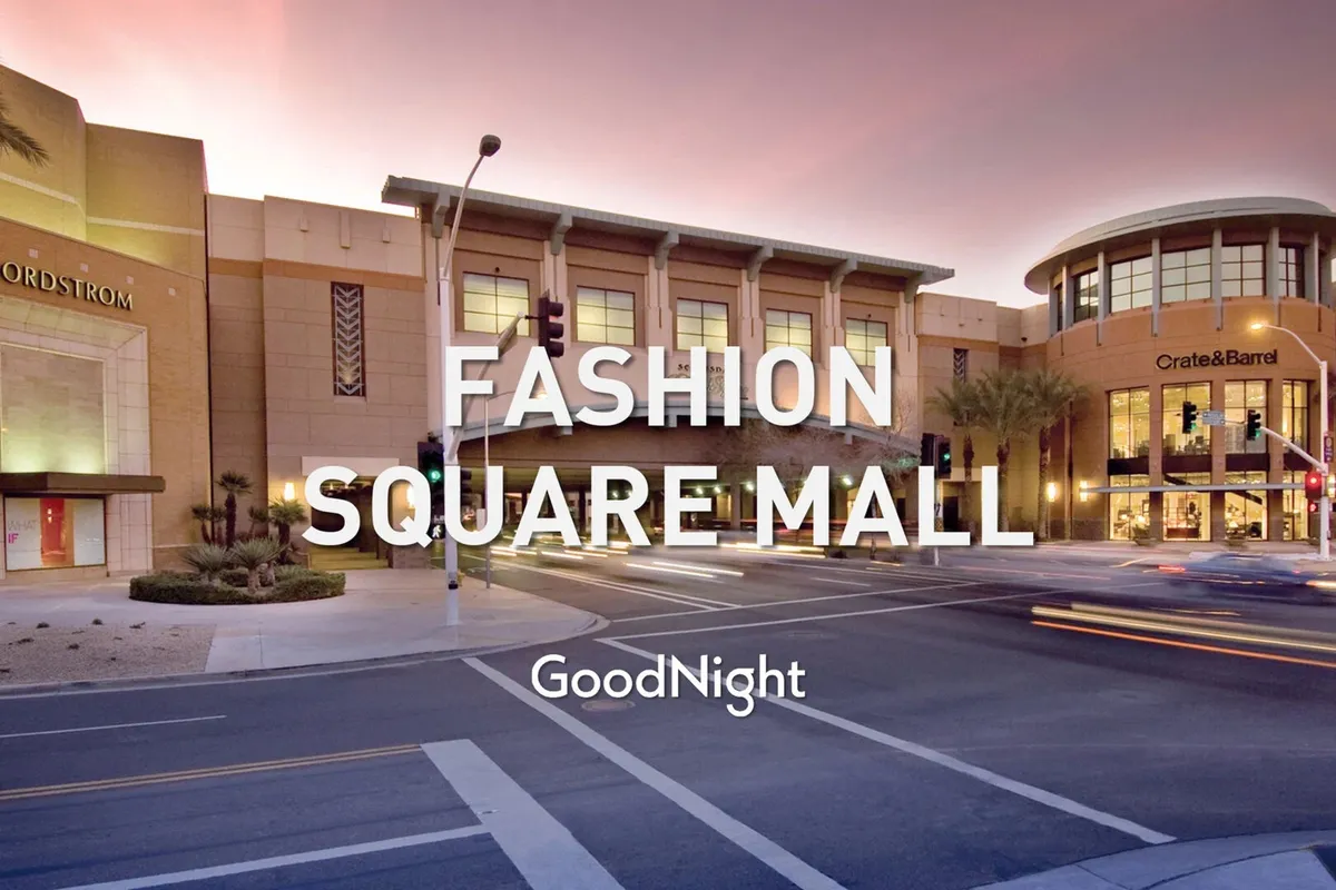 A dynamic exterior shot of the Scottsdale Fashion Square area, showing the Nordstrom and Crate & Barrel storefronts, palm trees, and bustling pedestrian traffic. The scene is lively, suggesting a premier shopping and social destination with seasonal events and festivities.